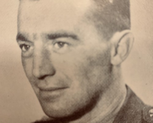 a head and shoulder photo of a young Lt. John Counsell in military atire