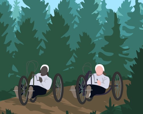 Two people out for a handcycle trip in the forest.