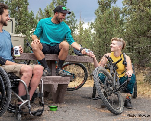 A group of both disabled and non-disabled people go for a bike ride. A group of both disabled and non-disabled people go for a bike ride.