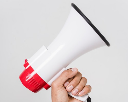 A hand holding a megaphone.