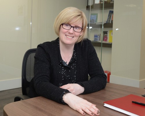 Carla Qualtrough at a desk