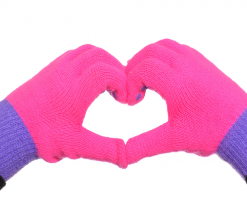 hands in gloves making the shape of a heart