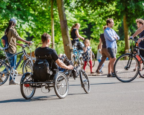 a group of bikers including a person with a hand cycle