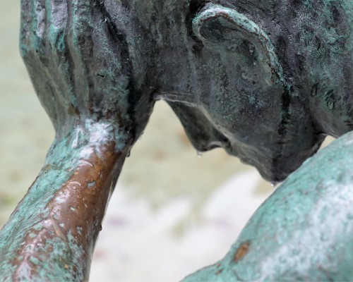 statue of man holding head