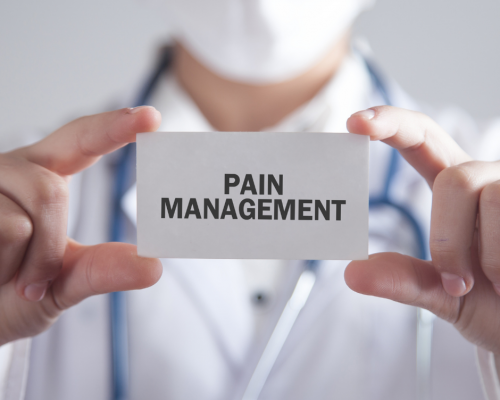 doctor holding up card that says 'pain management'